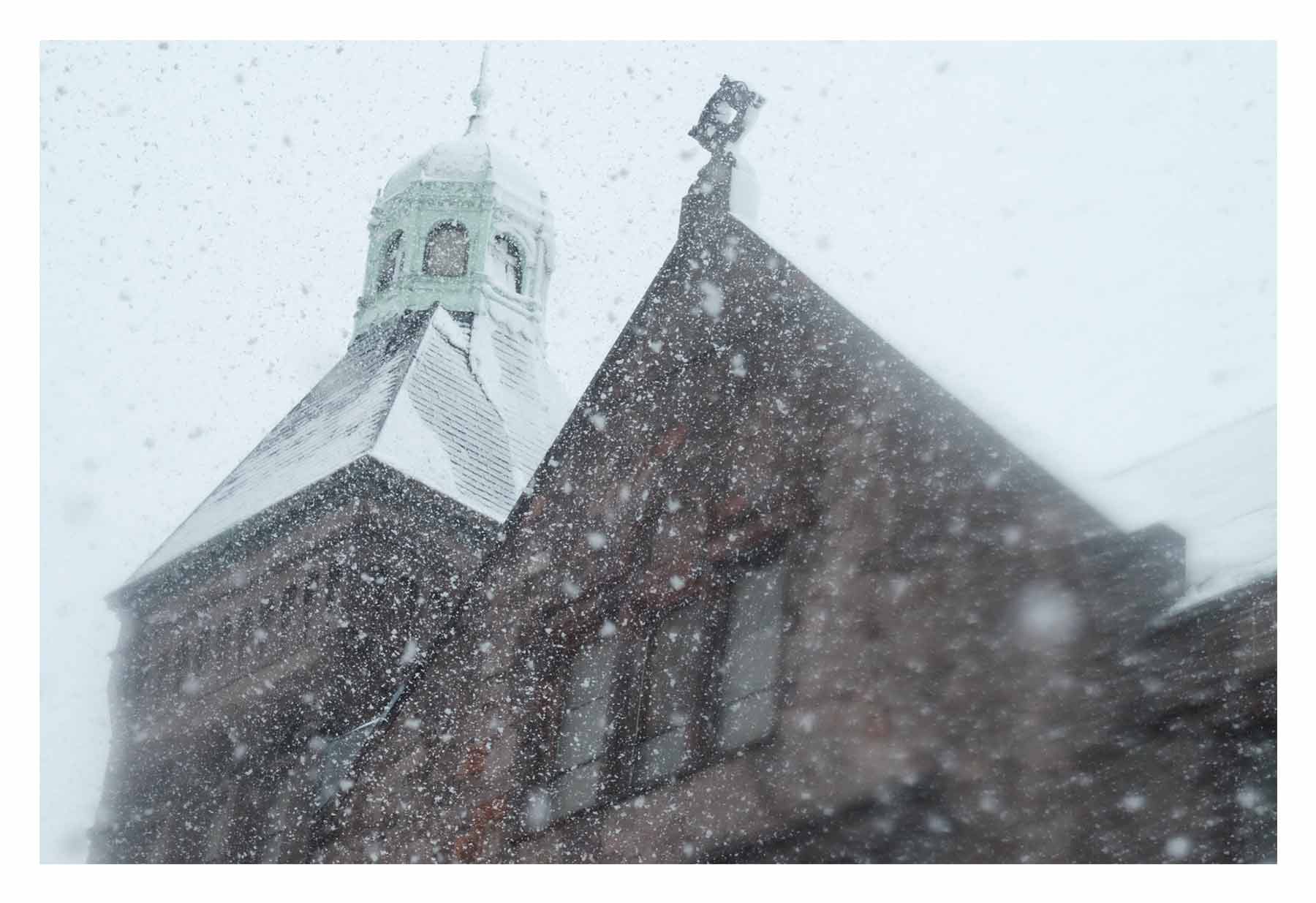 Snow falls around a Philly church